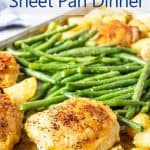 A sheet pan filled with potatoes, green beans and chicken.