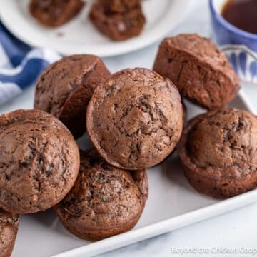 Zucchini muffins on a white platter.