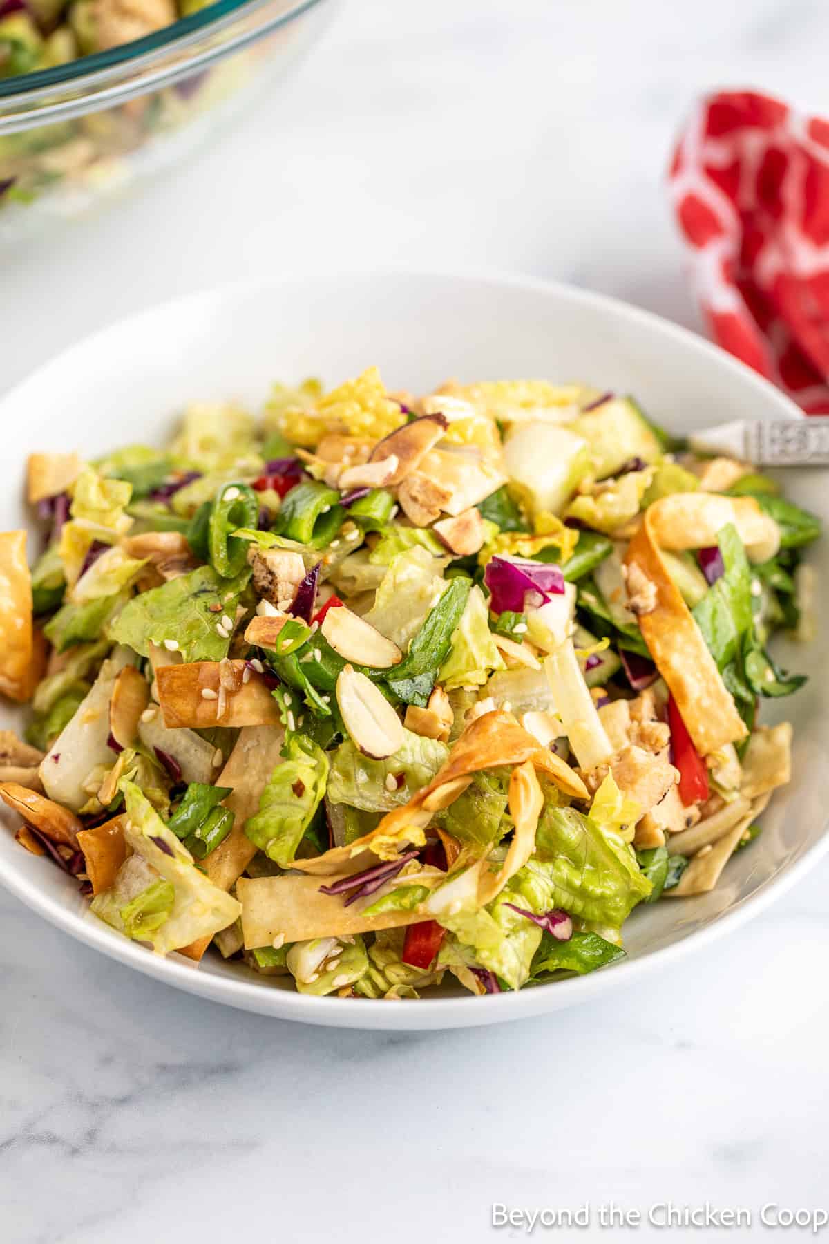 A chopped salad in a white bowl.