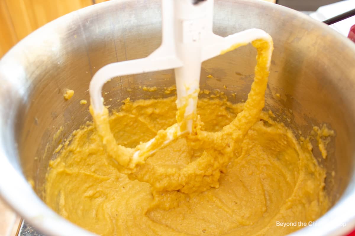 Cookie dough in a mixing bowl with a paddle attachment.