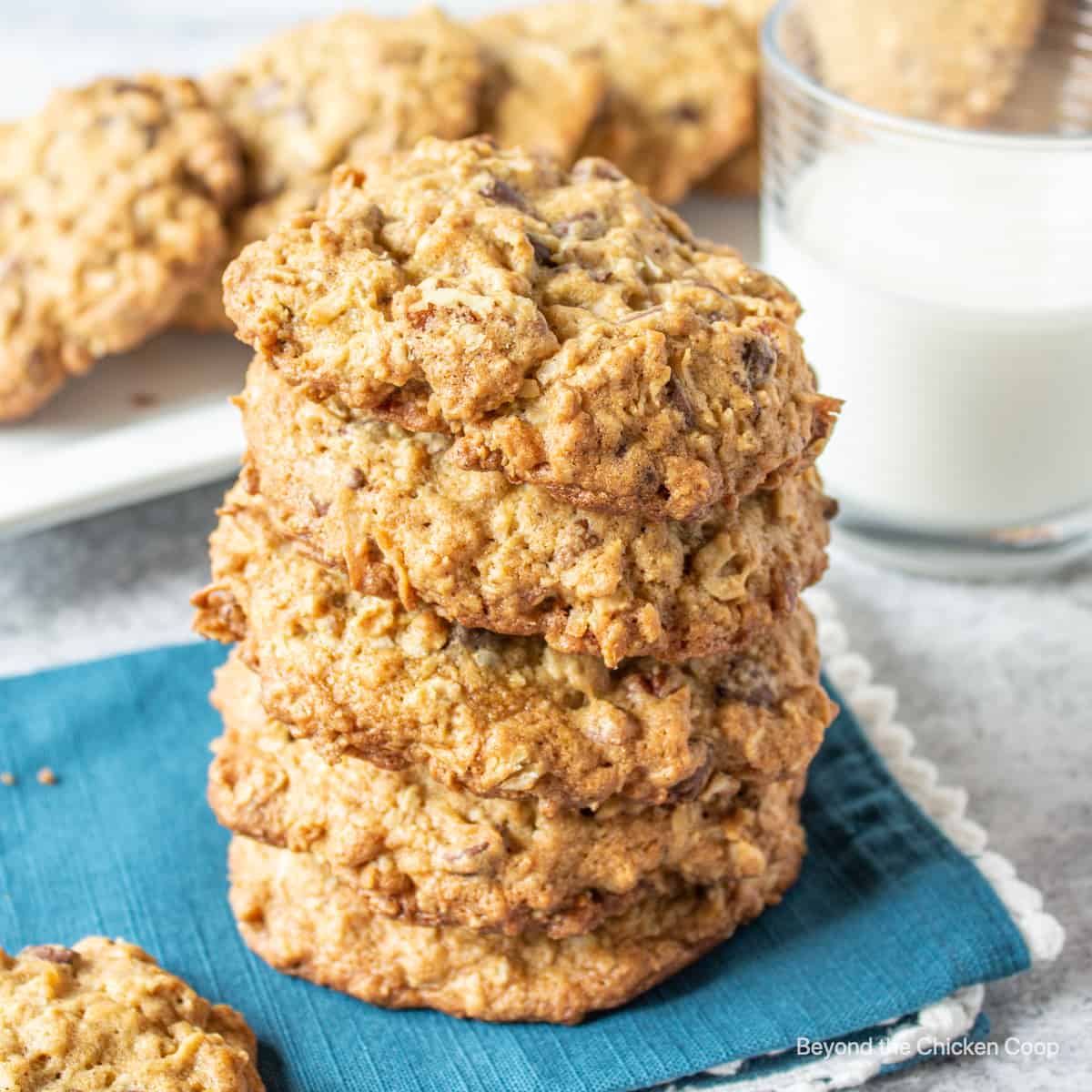 A stack of cowboy cookies on a blue napkin.