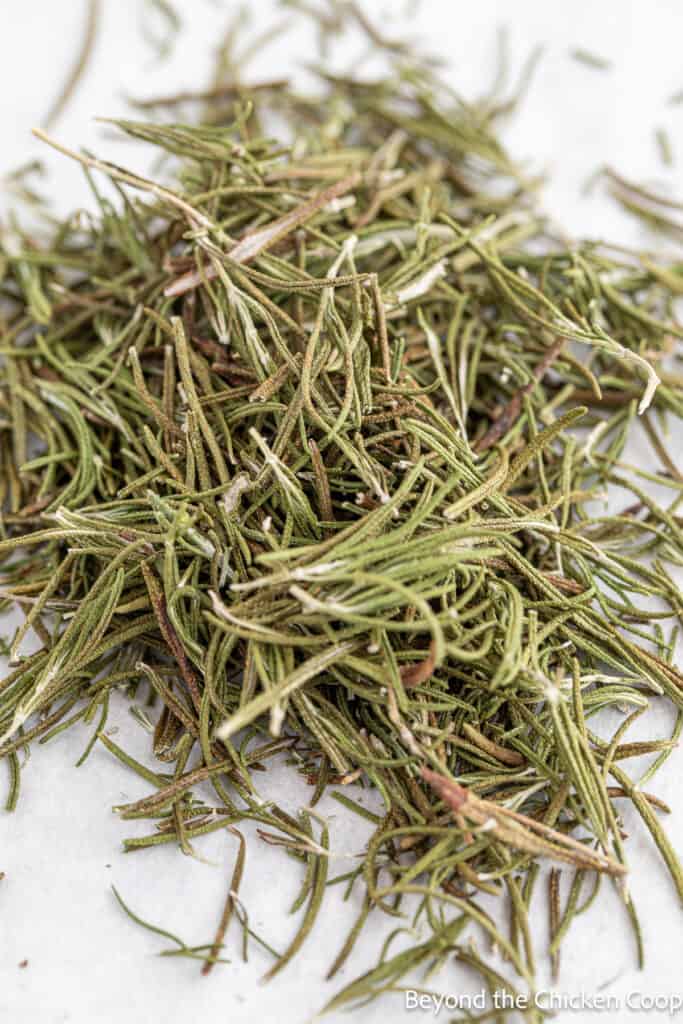 A pile of dehydrated rosemary leaves.