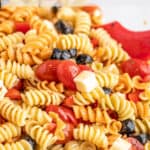 Noodles with tomatoes and black olives.