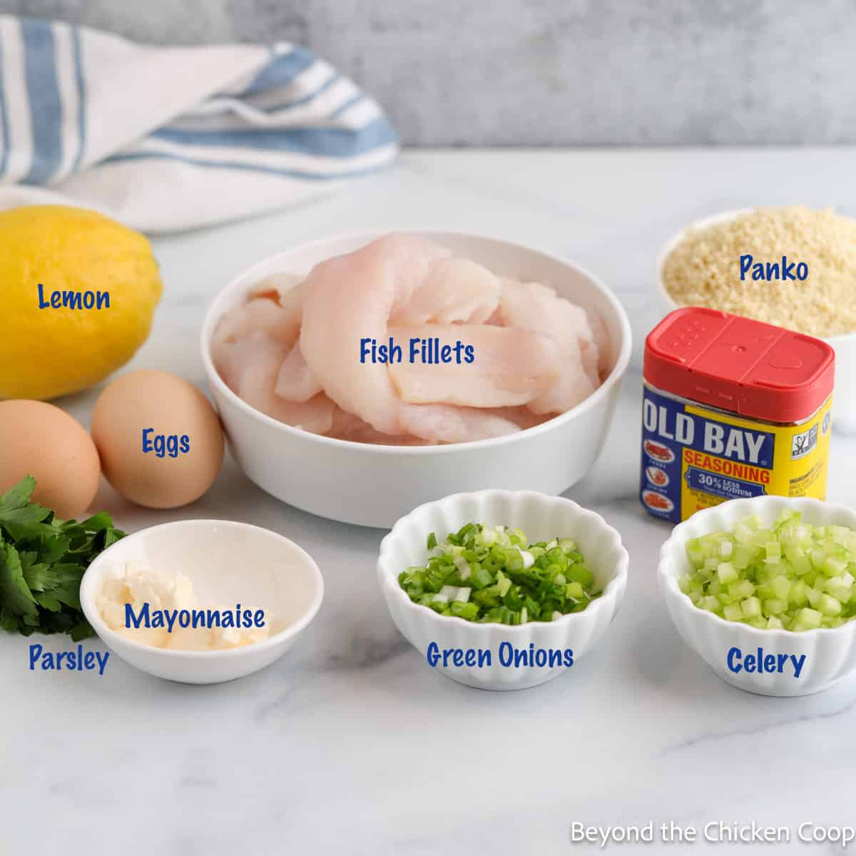 Small bowls filled with ingredients for making fish cakes. 