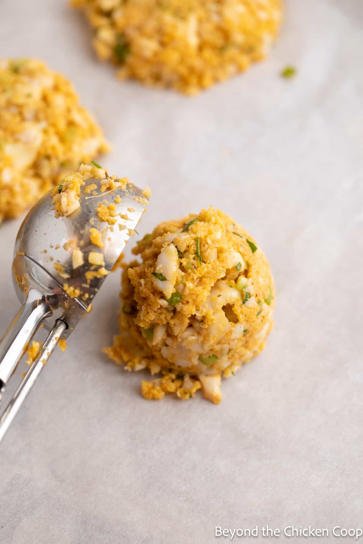 Forming fish cakes with a scooper.