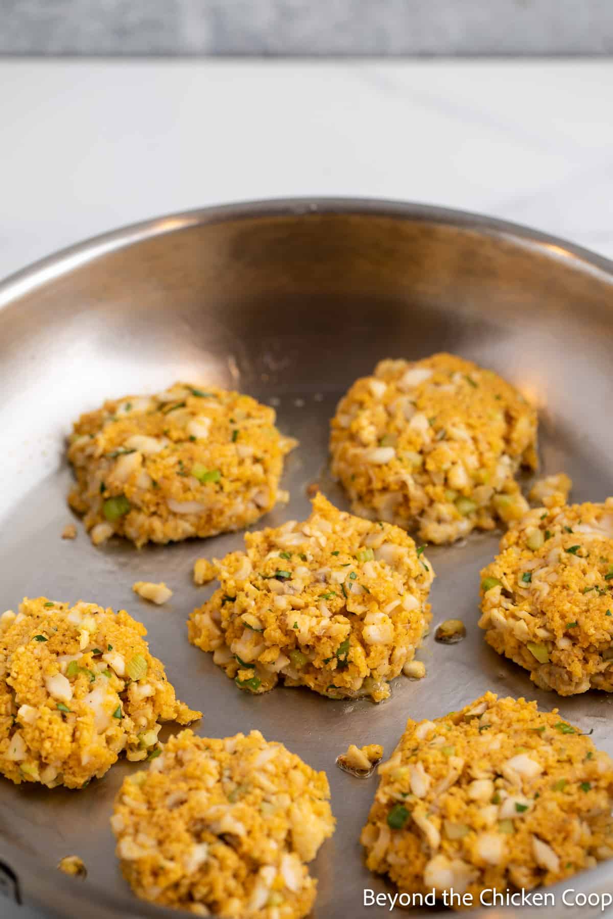 Cooking fish patties in a pan. 