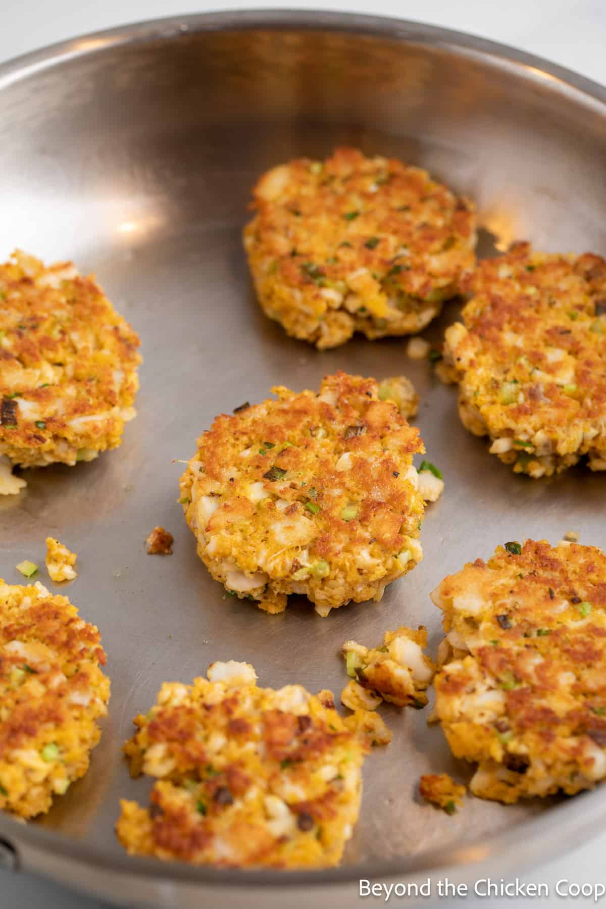 Cooking fish cakes in a pan.