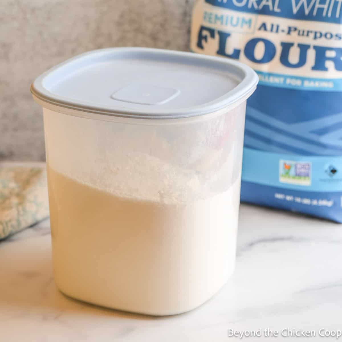 A plastic container filled with flour.