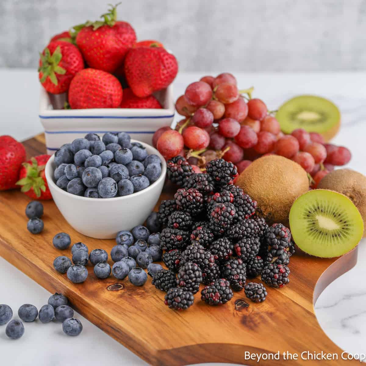 Fresh fruit on a wooden cutting board. 