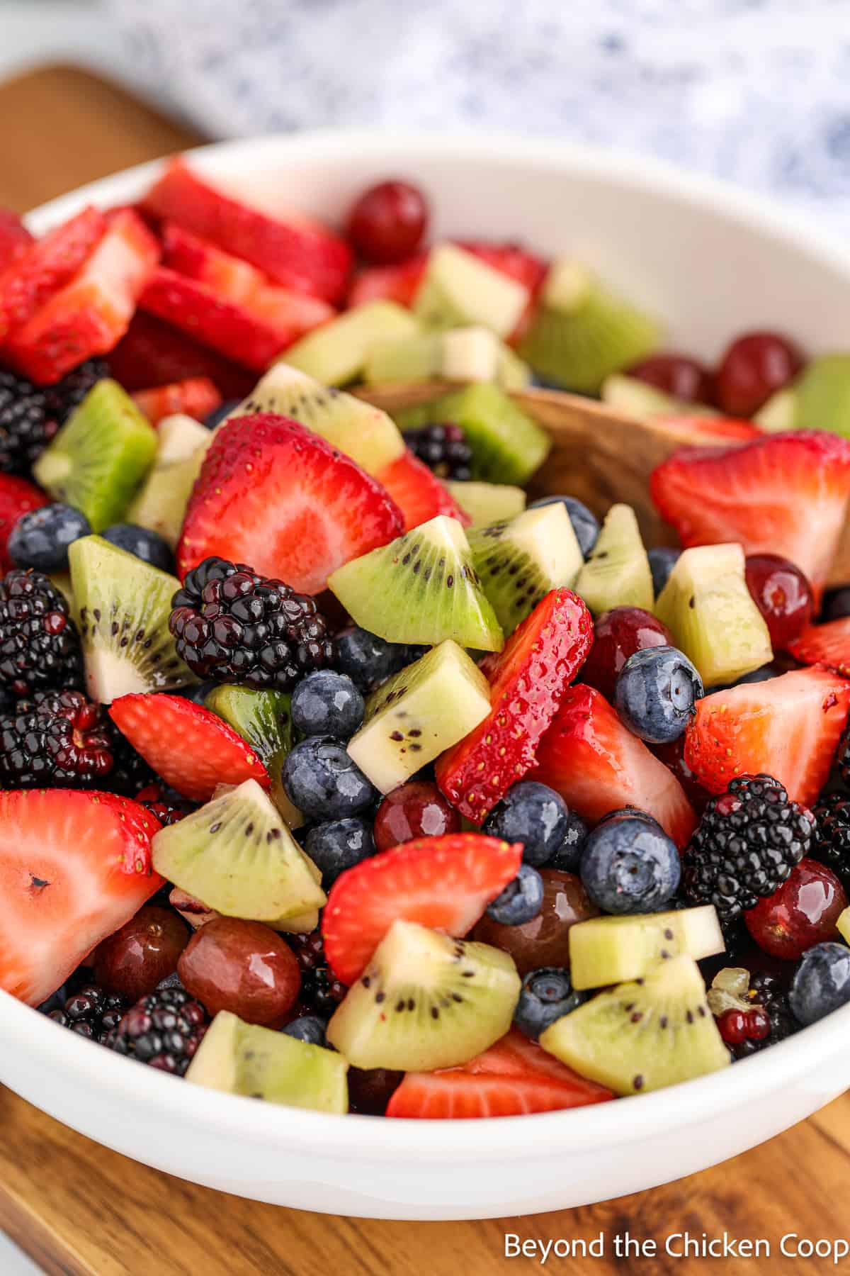 Fruit salad in a white bowl.