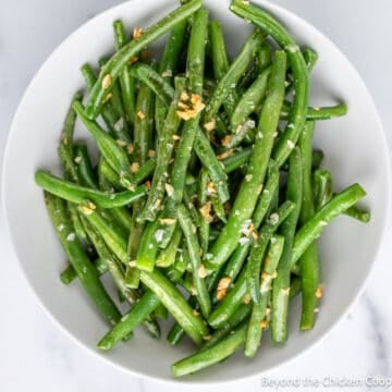 Green beans in a white bowl.