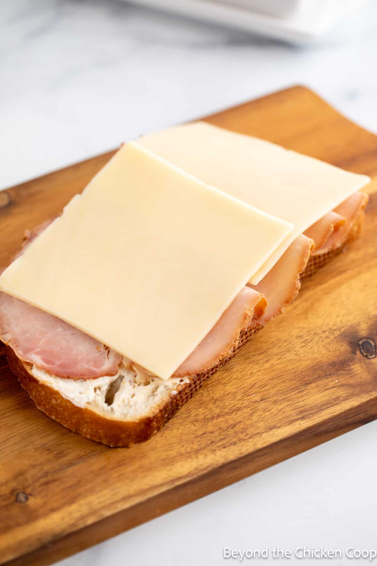 Adding ham and cheese to bread. 