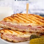 Grilled panini sandwich filled with ham and cheese.