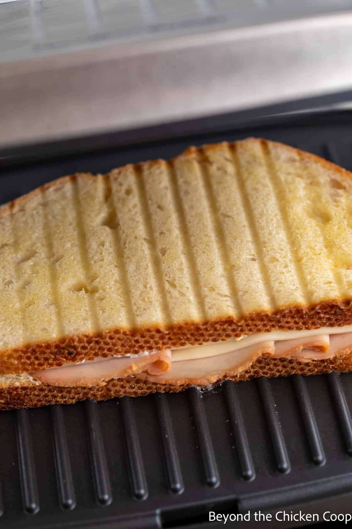 A sandwich in a panini grill. 