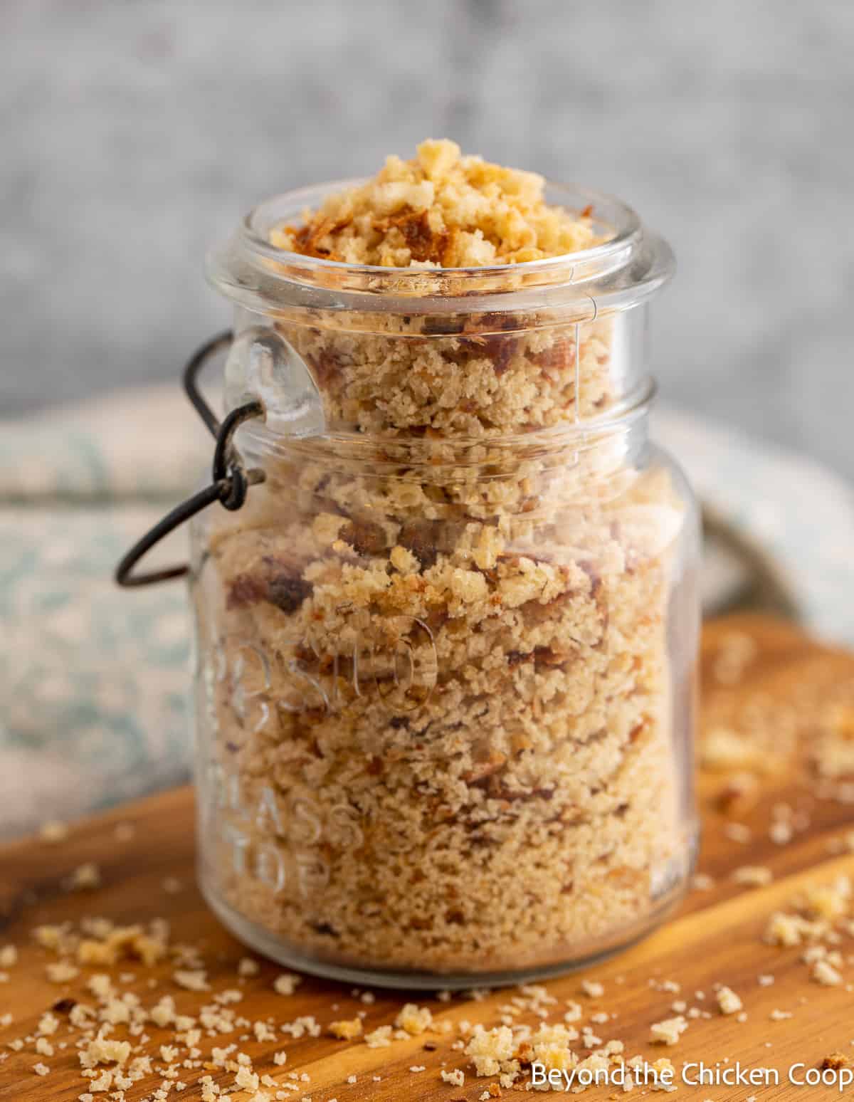 An old fashioned canning jar filled with dried bread crumbs. 