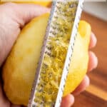 Zesting a lemon with a hand grater.