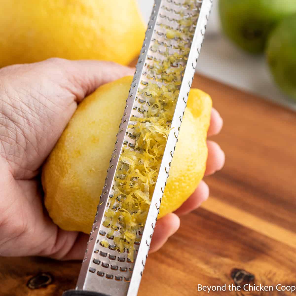 Zesting a lemon with a microplane grater. 