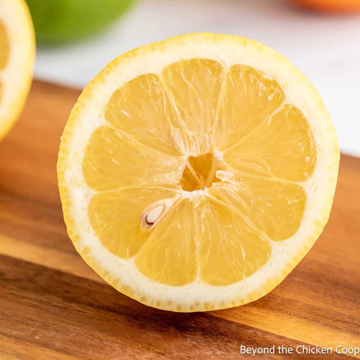 A half of a lemon on a board. 