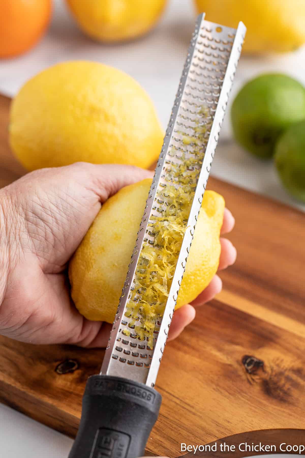 Removing lemon peel with a grater. 