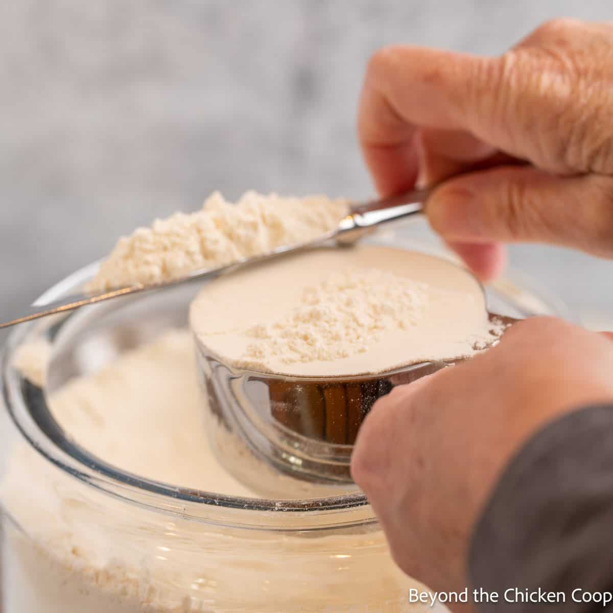 Leveling flour on a measuring cup. 