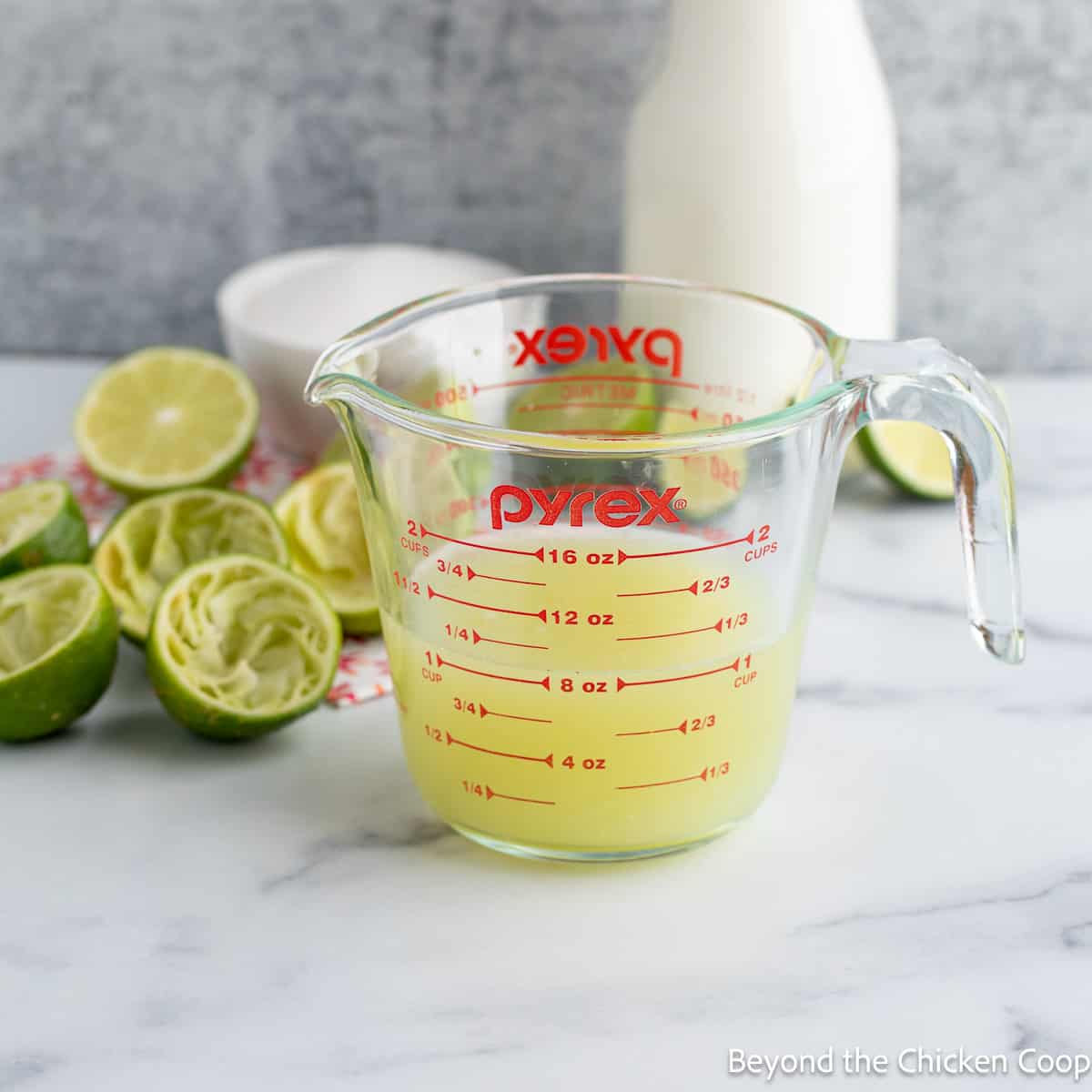 Lime juice in a glass measuring cup.