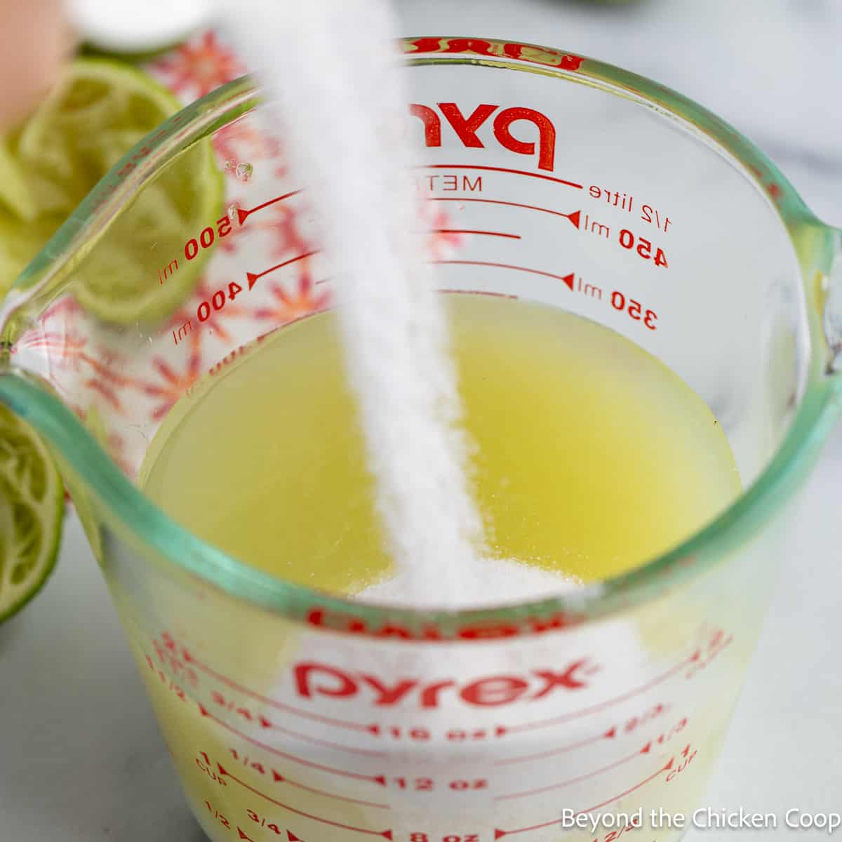 Combining sugar and lime juice together. 