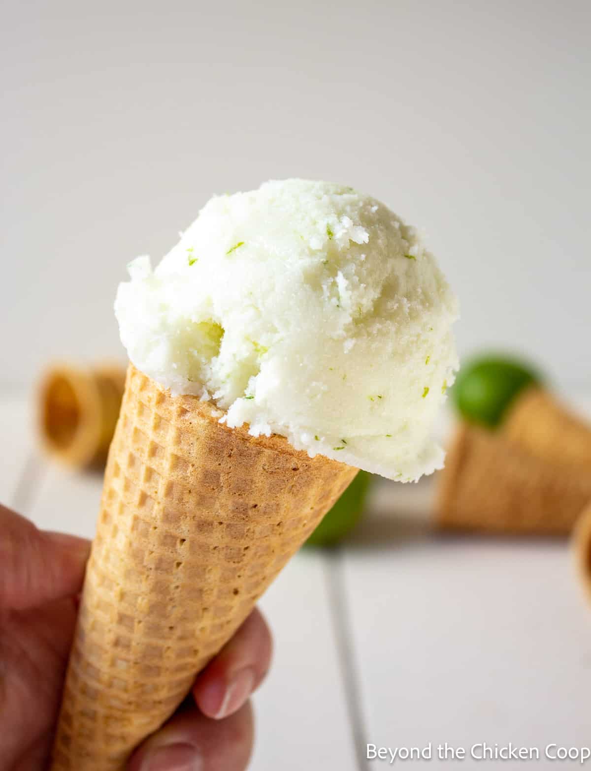 A scoop of ice cream on a sugar cone. 