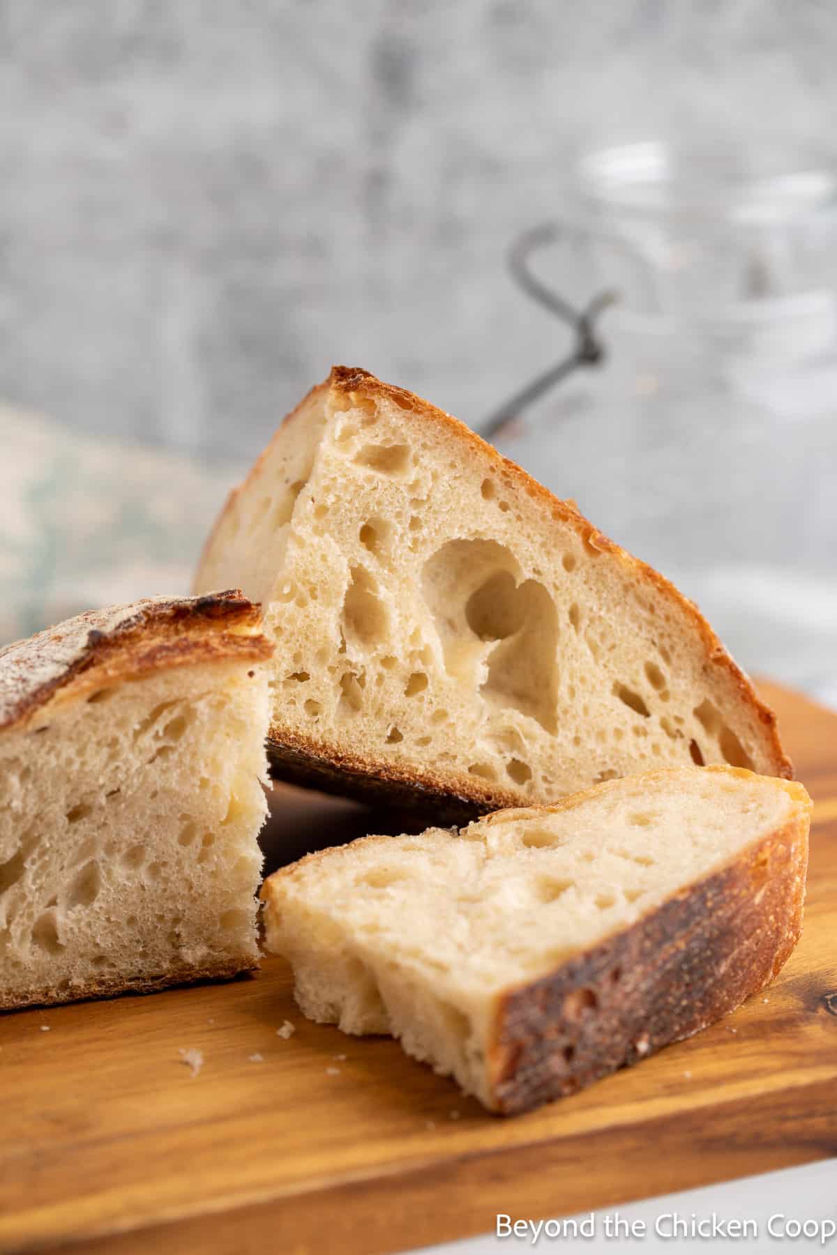 Large chunks of sourdough bread on a board. 