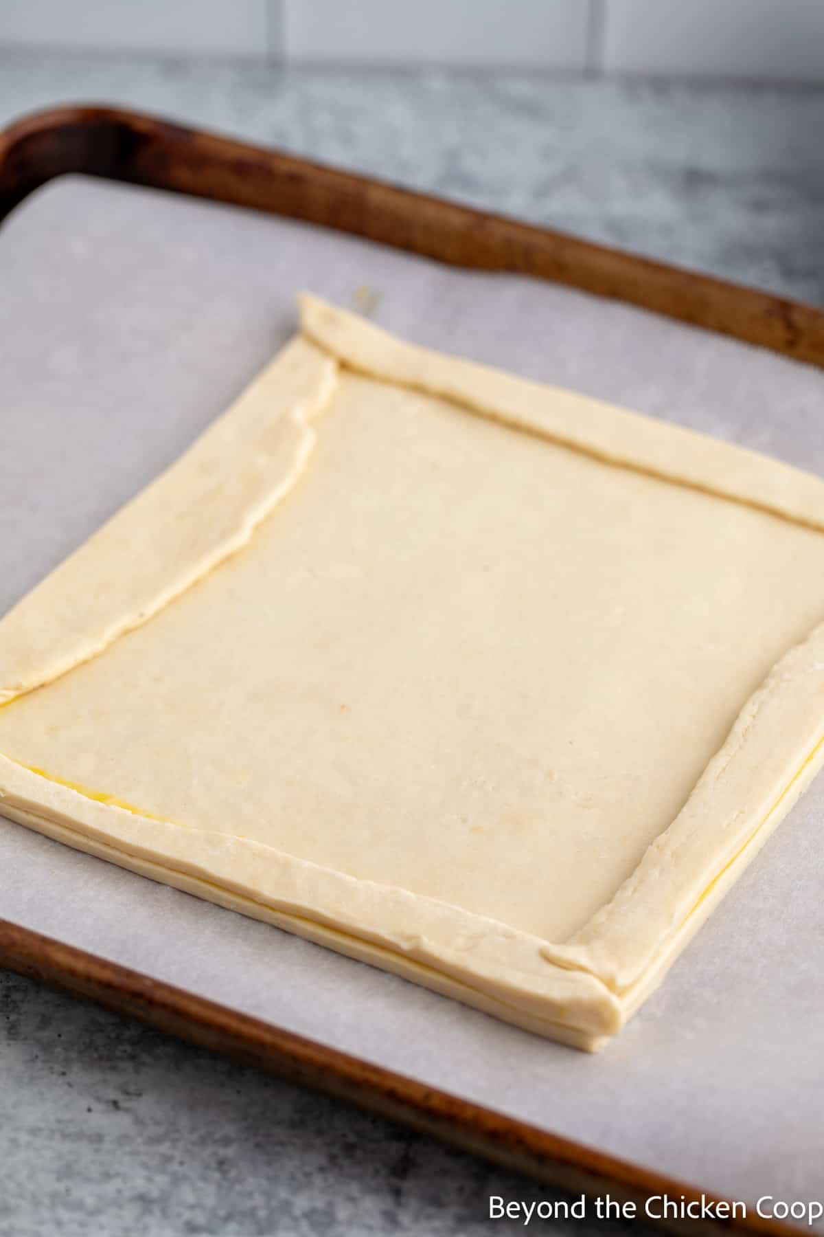Puff pastry dough on a baking sheet. 
