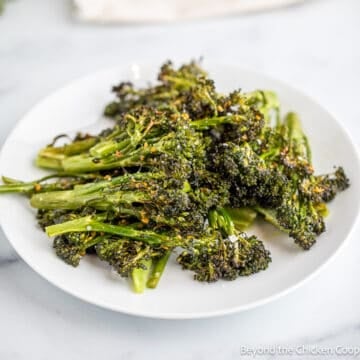 Roasted broccoli on a white plate.