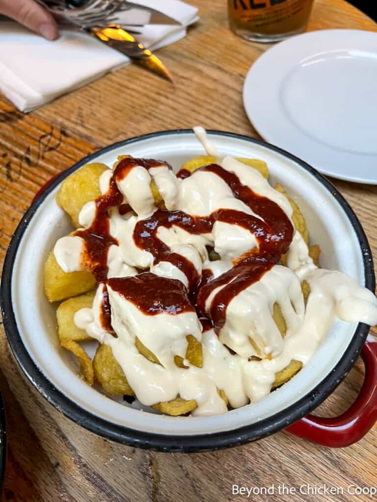 Patatas Bravas in a metal bowl. 