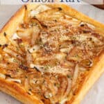 Puff pastry onion tart on a baking sheet.