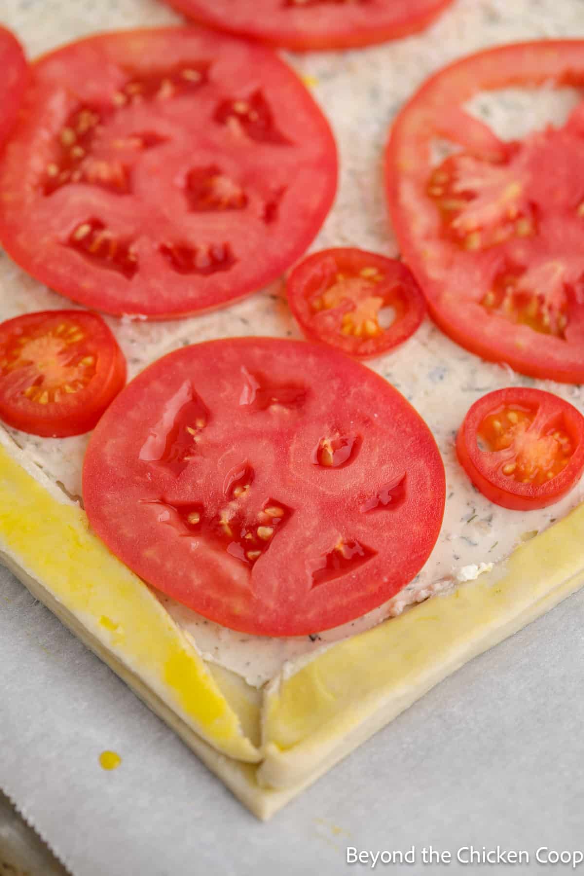 Sliced tomatoes on an unbaked tart. 