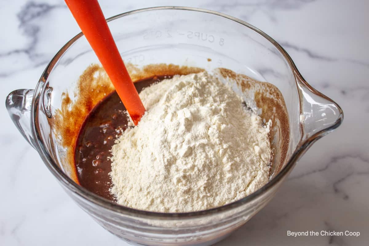 Flour in a bowl with a chocolate batter.