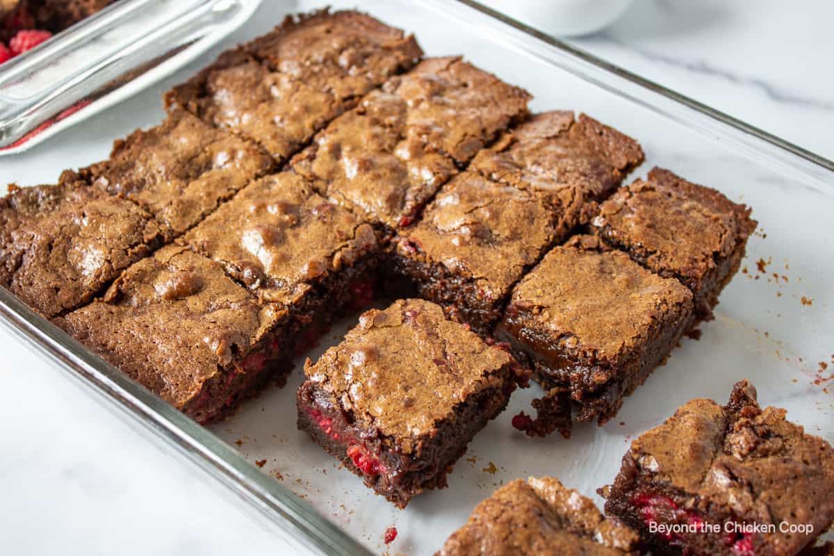 A glass pan filled with squares of brownies.