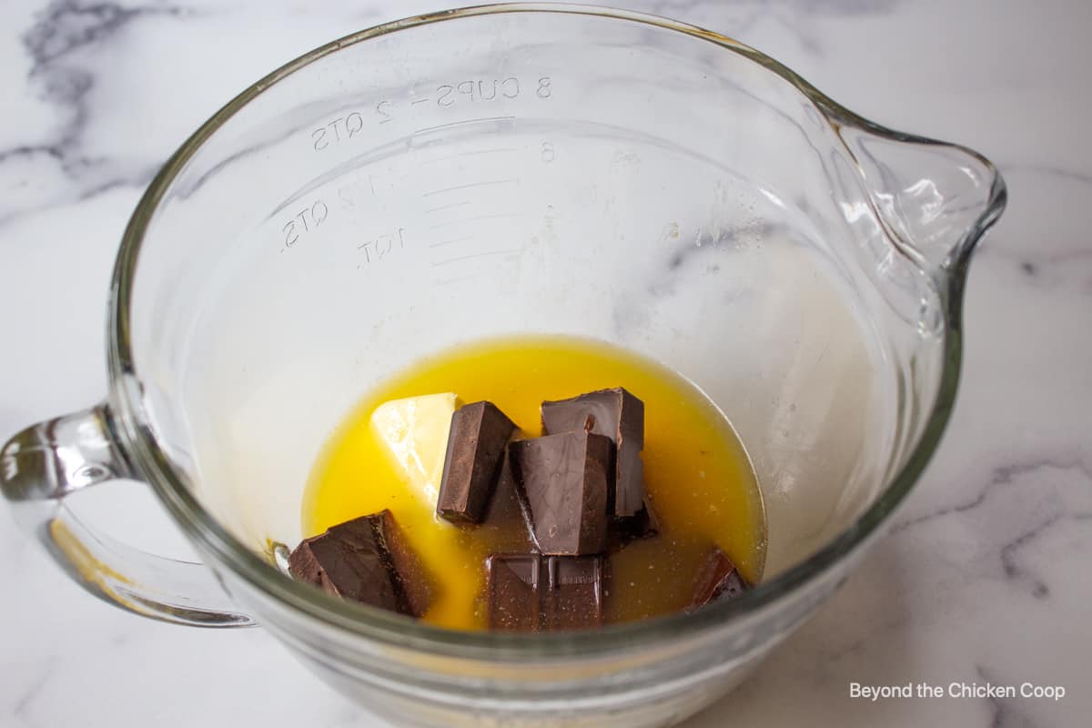 A glass bowl filled with butter and chocolate.