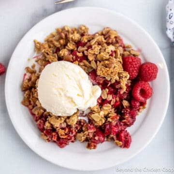 Raspberry dessert topped with a scoop of ice cream.