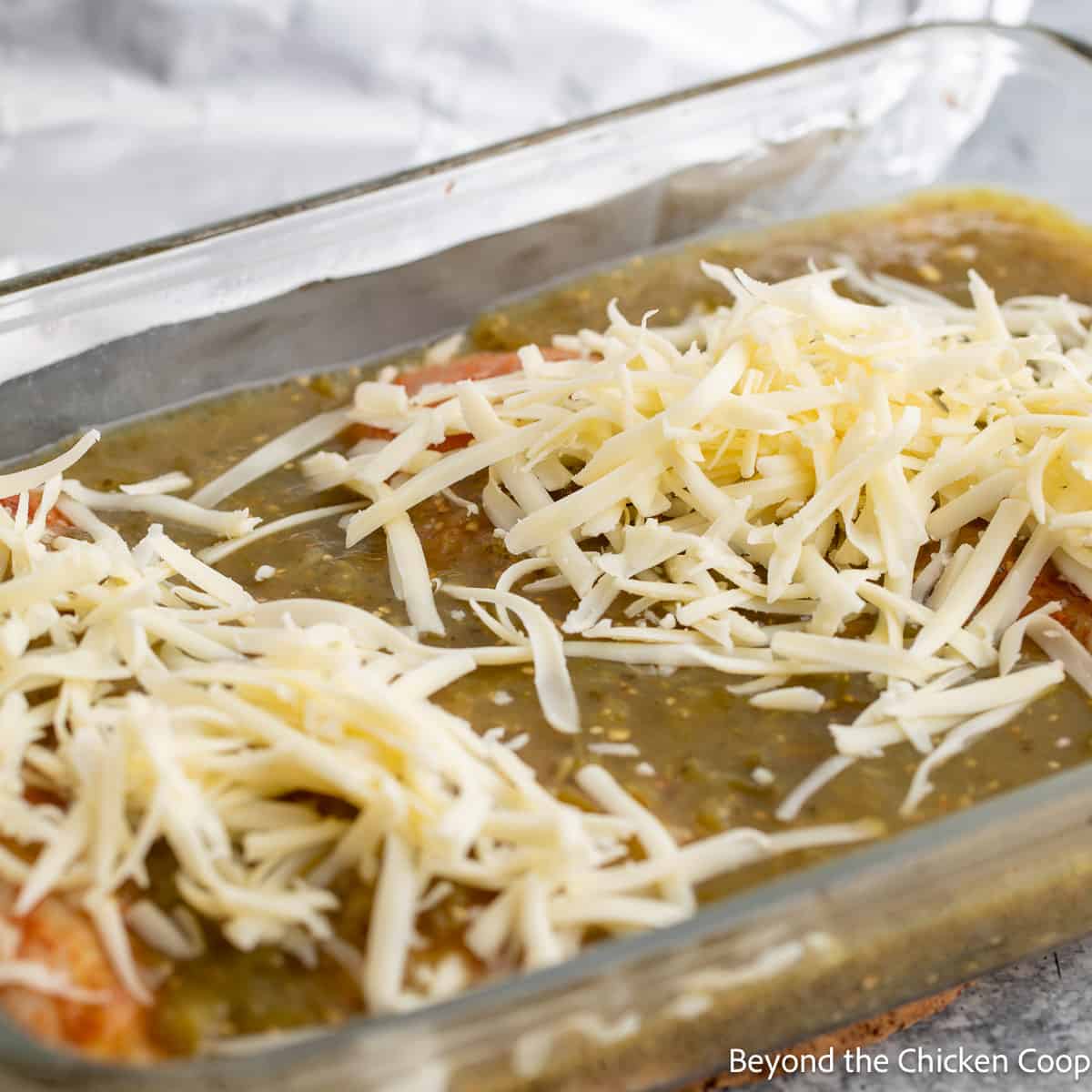 Shredded cheese over a casserole dish. 