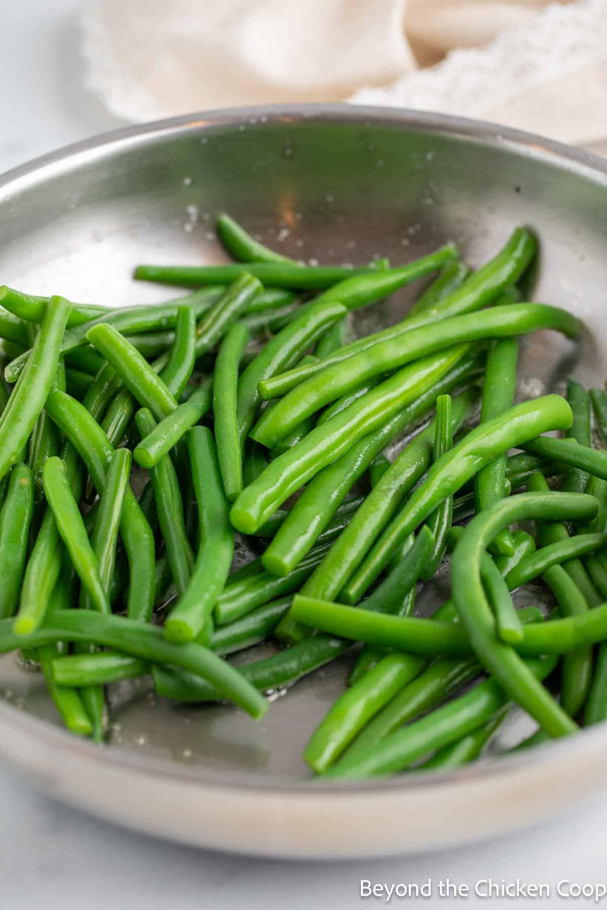 Sautéing green beans in a skillet.  