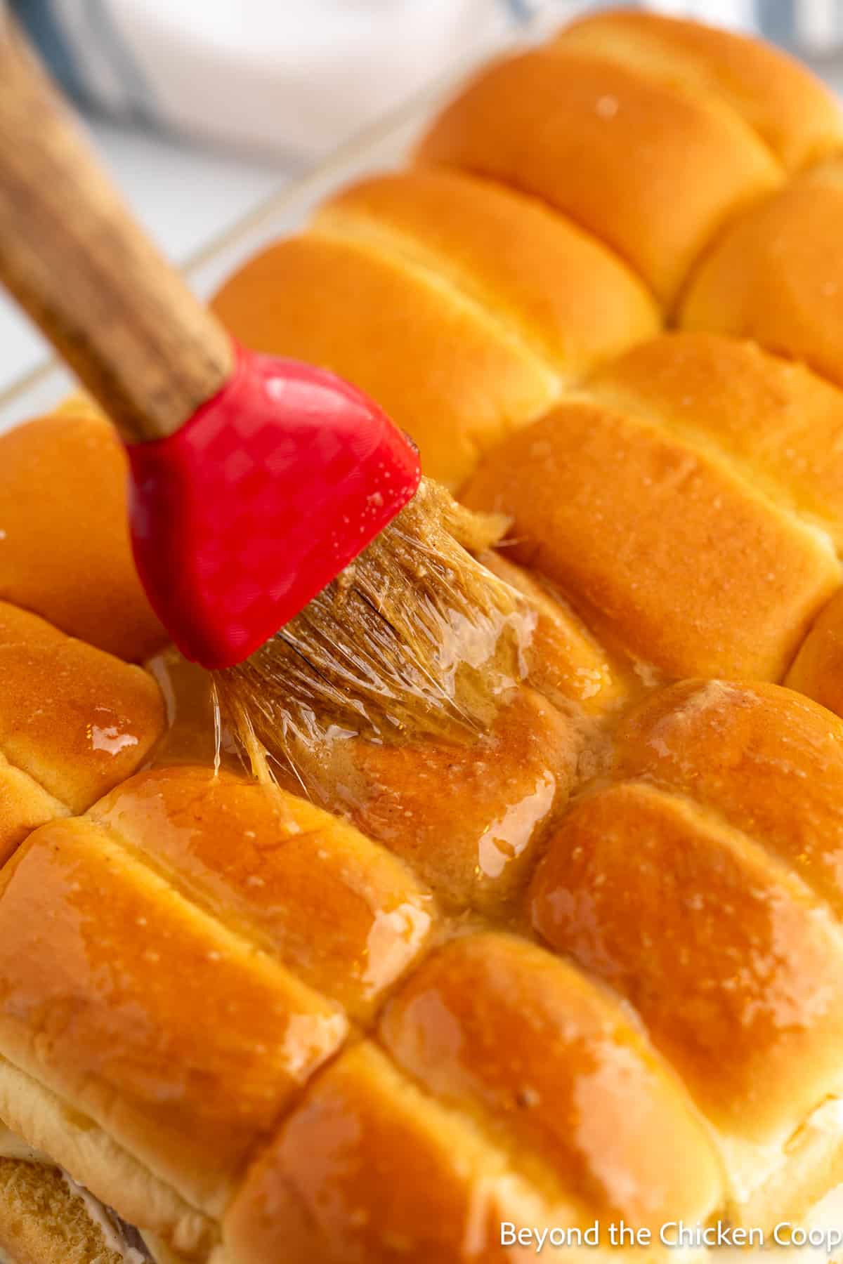 Brushing the top of bread with butter. 