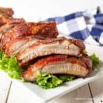 Grilled ribs on a bed of lettuce.