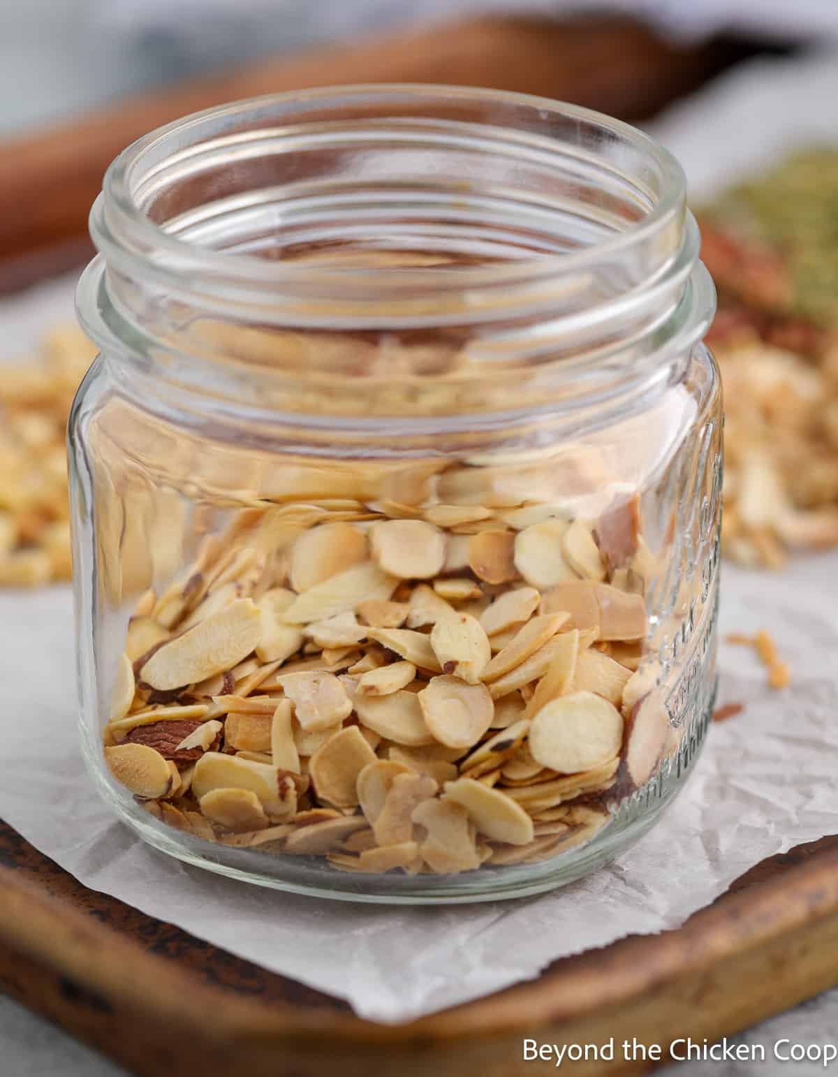 A jar filled with sliced almonds. 