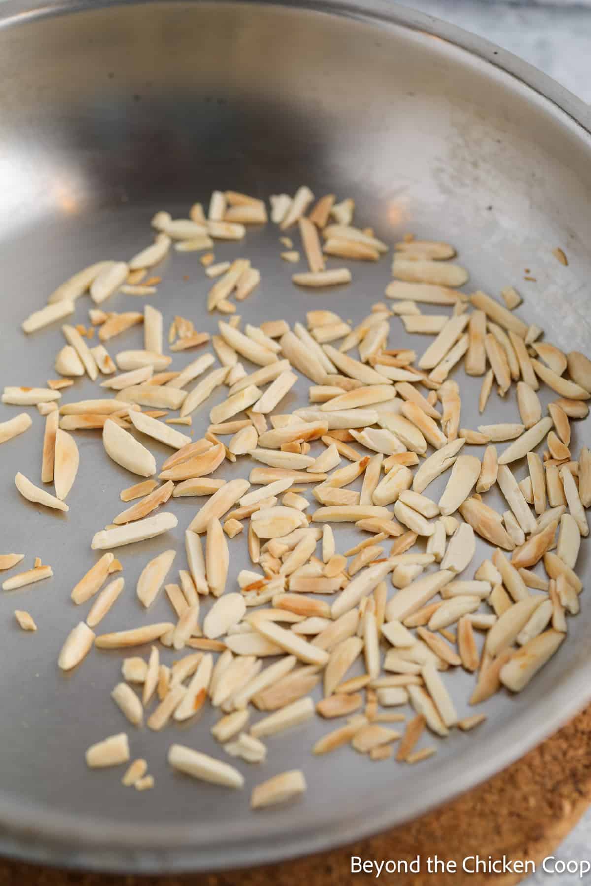 Slivered almonds in a skillet.