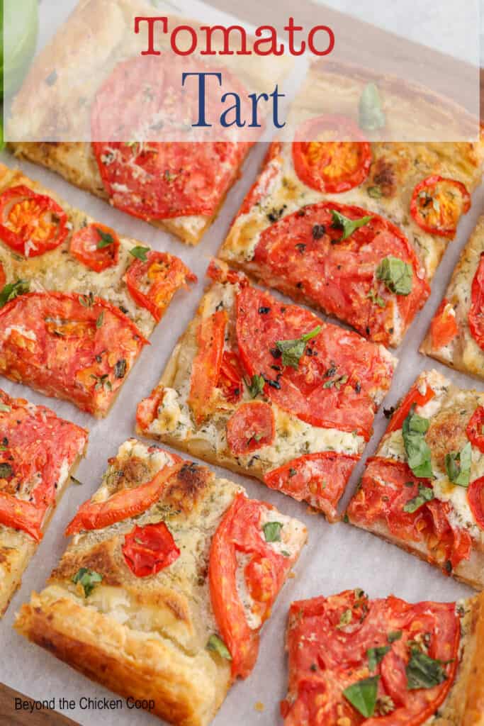 Puff pastry and tomato tart sliced into small squares.