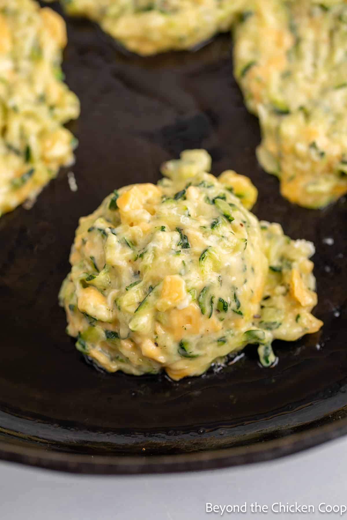 Scoops of batter in a skillet. 