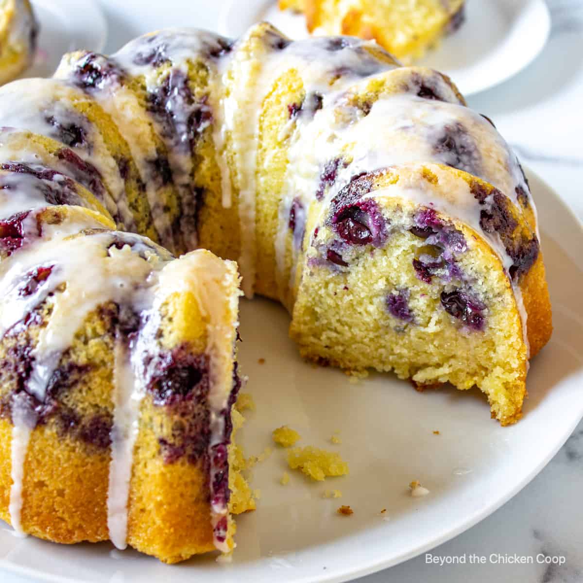 A blueberry lemon bundt cake on a white plate. 