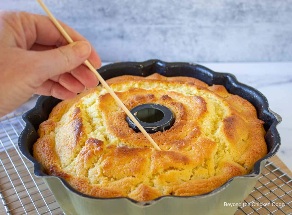 Testing a cake for doneness with a wooden skewer.