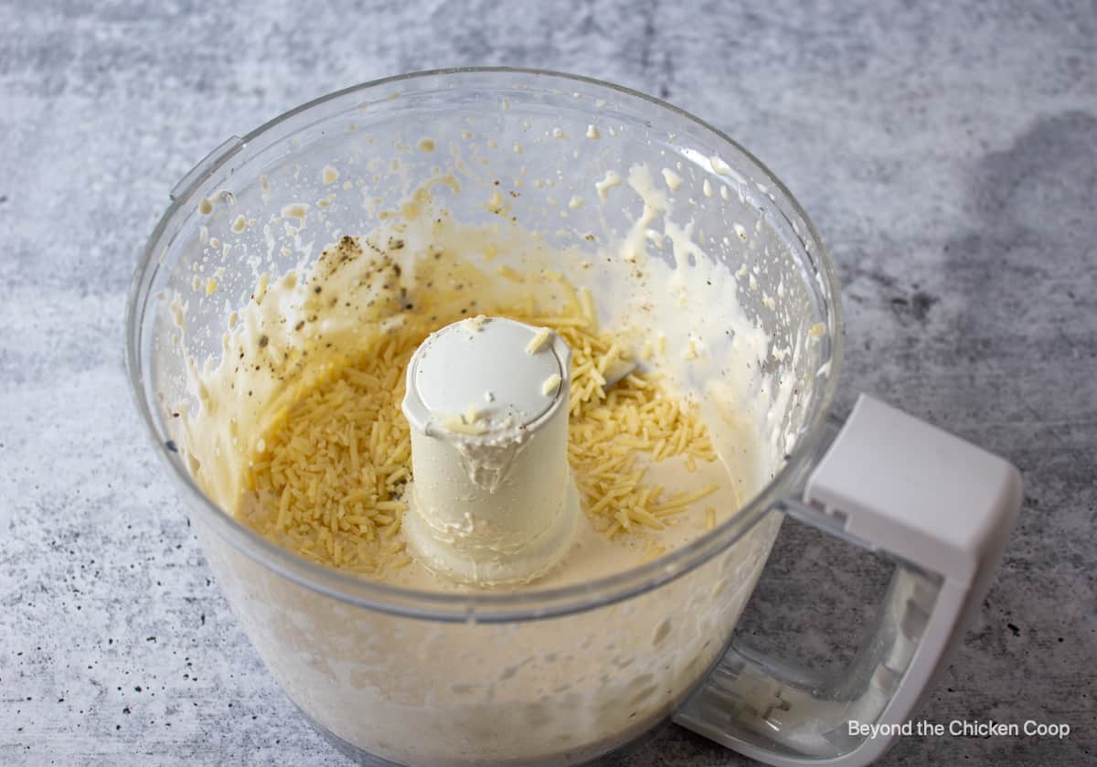 Caesar salad dressing in a food processor bowl.