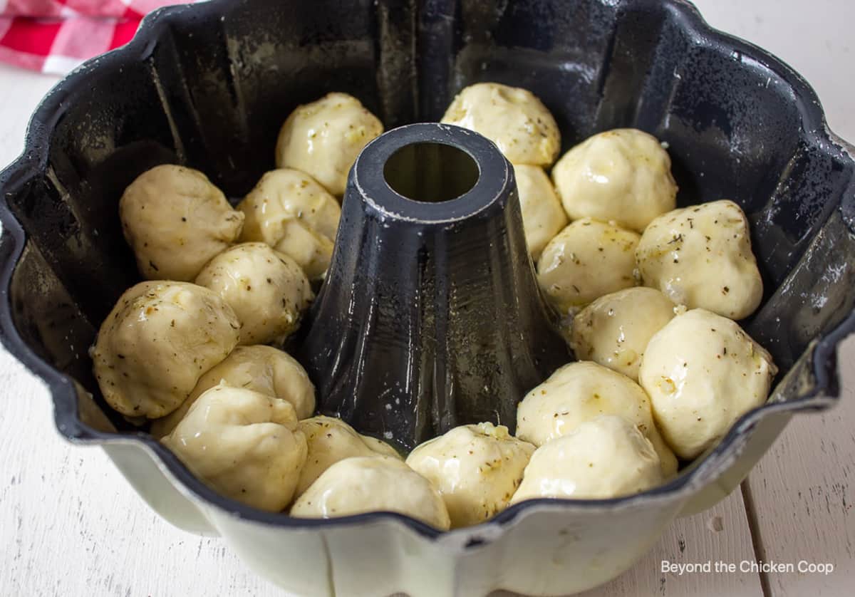 Round balls of dough in a bundt pan.