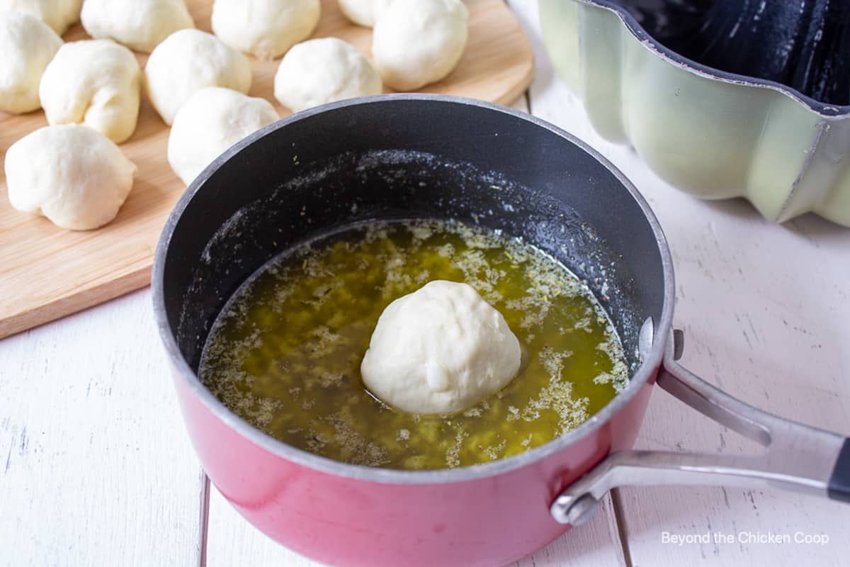 Bread dough in a pan of melted butter.